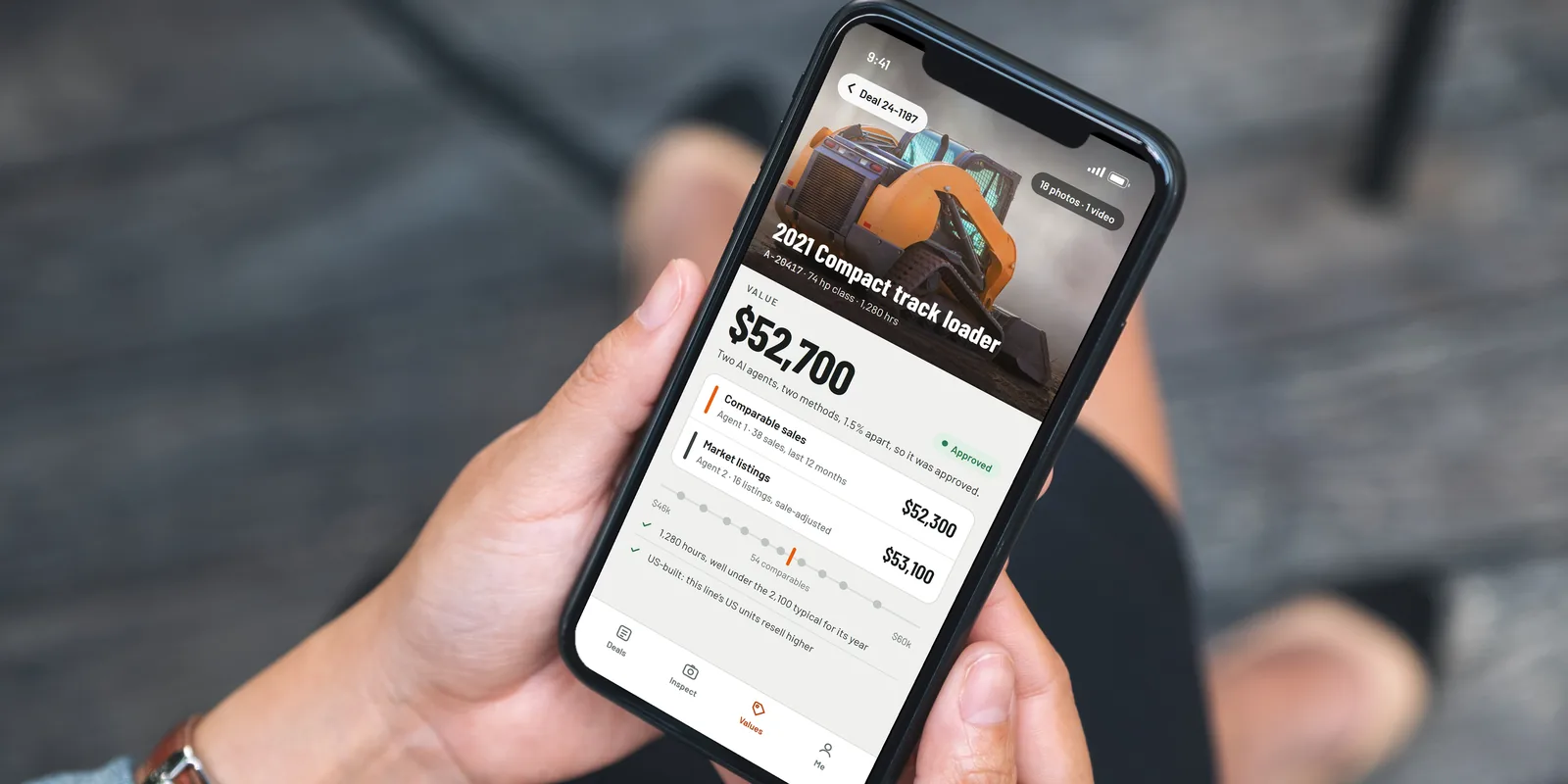 The field app in two hands: a compact track loader valued at $52,700 by two AI agents, 1.5 percent apart, so it was approved